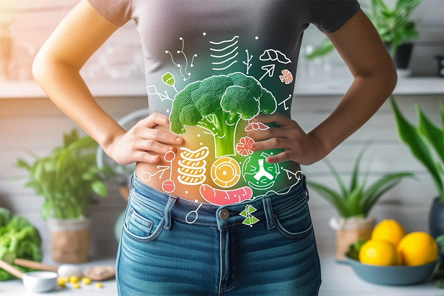 Woman with healthy gut has her hands on her hips.