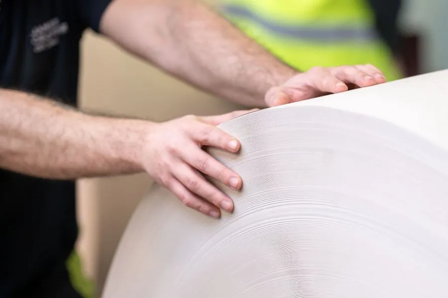 A person holding a roll of paper.