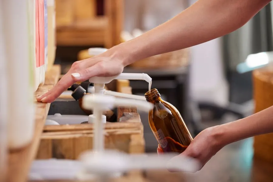 A person pouring liquid into a bottle.