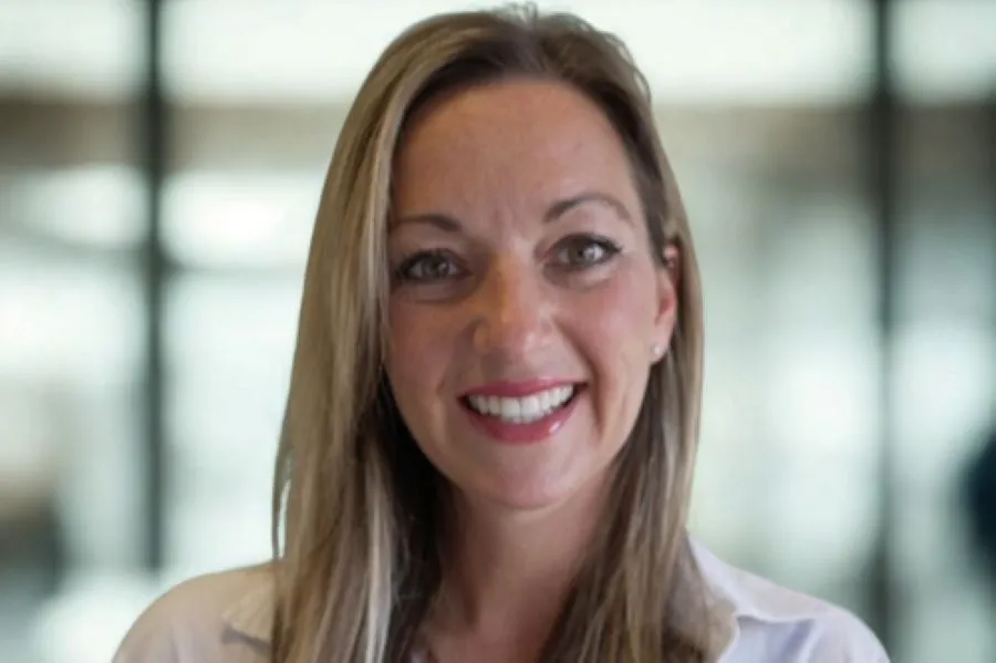 A woman smiling into the camera.