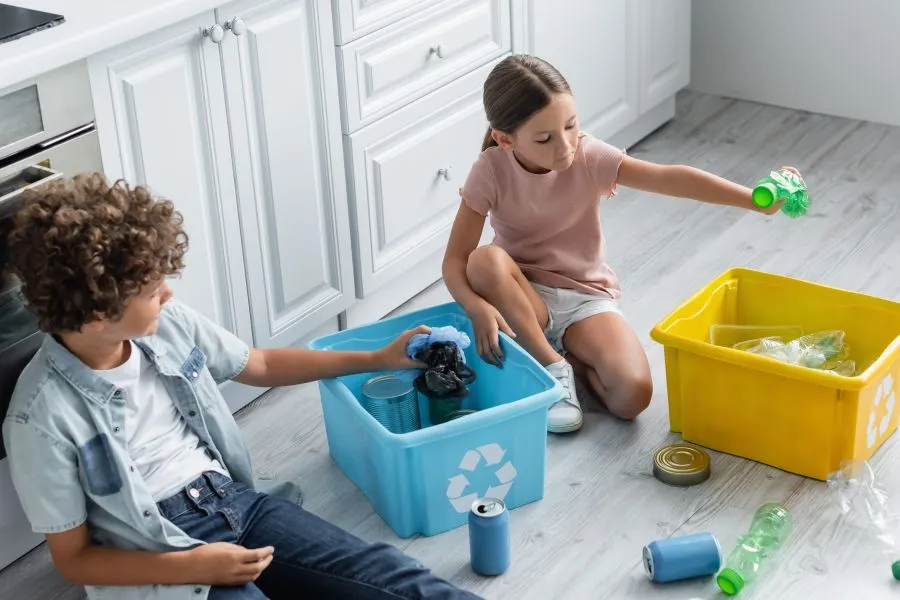 A child and child sorting garbage.