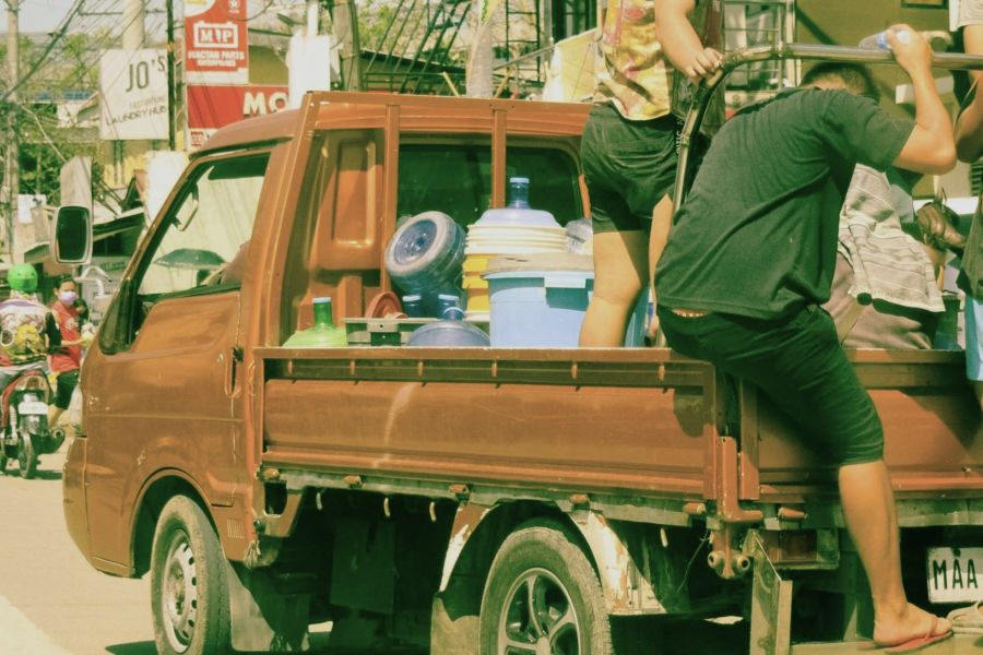 People on a truck with plastic bottles