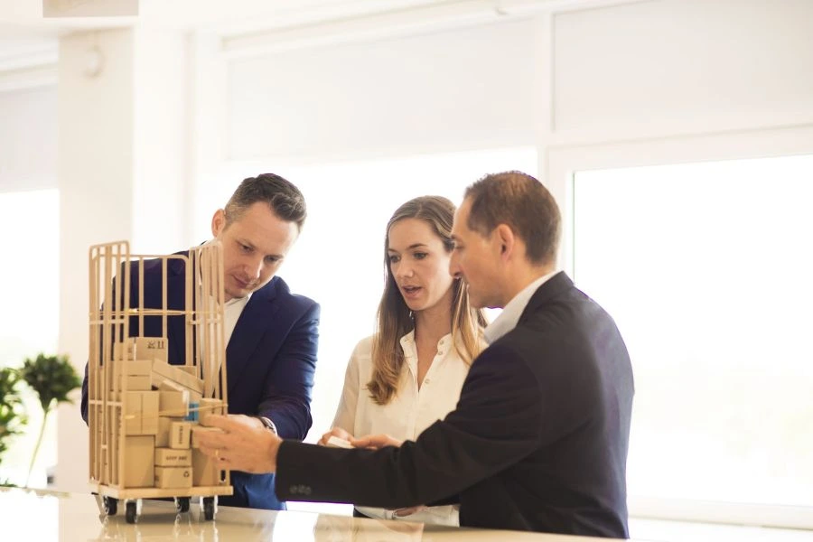 Three people discussing packaging design.