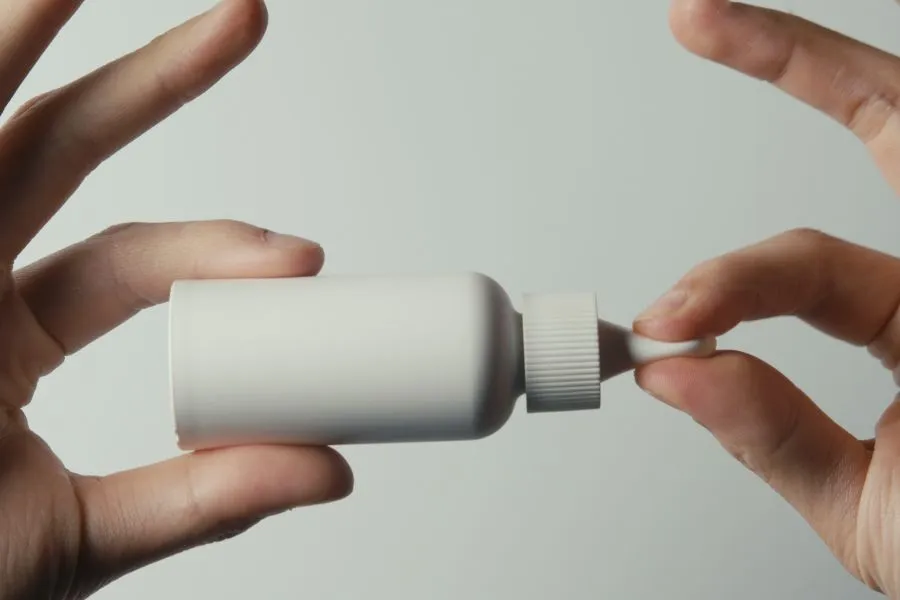 hand holding a grey paper based pipette