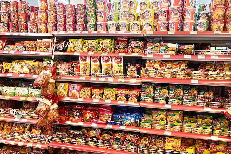Processed foods in supermarket aisle.