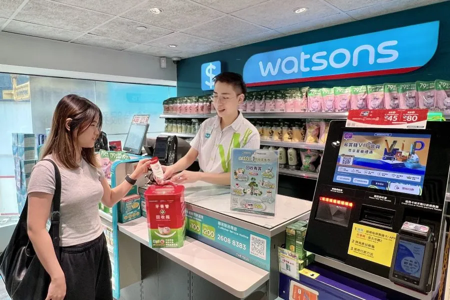 A woman returning a tube at a store.