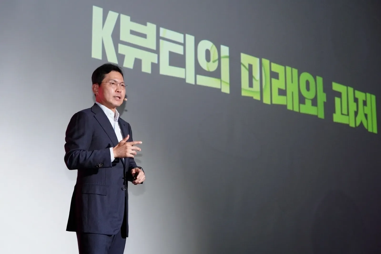 A man speaking on a stage.