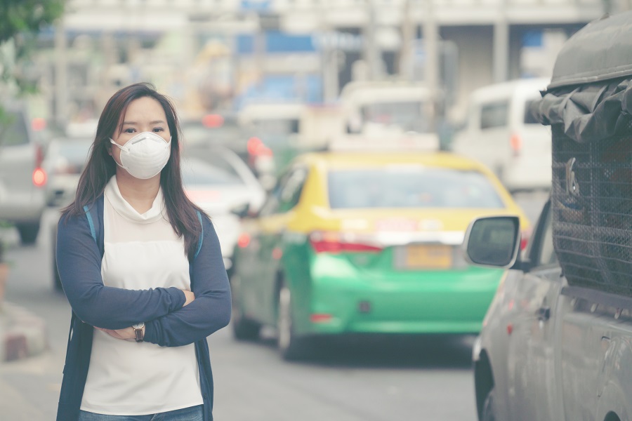 Woman breathing air pollution